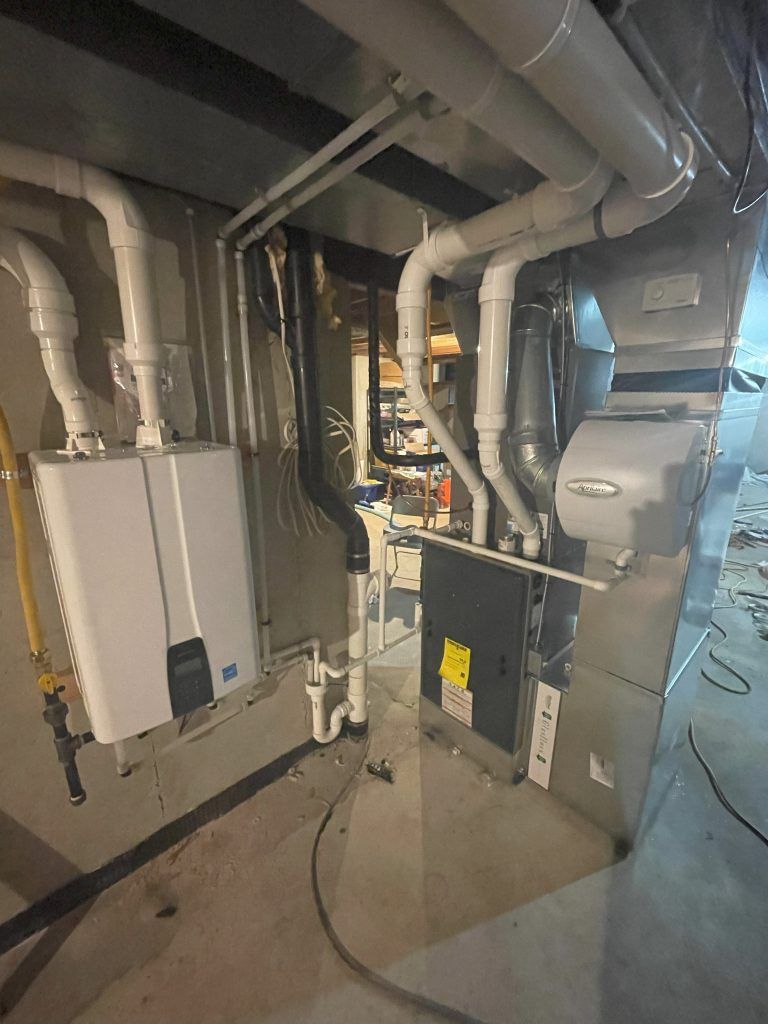 A basement with HVAC equipment, including a water heater, furnace, and ductwork.