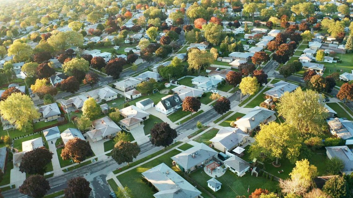 An aerial view of a residential neighborhood filled with lots of houses and trees.