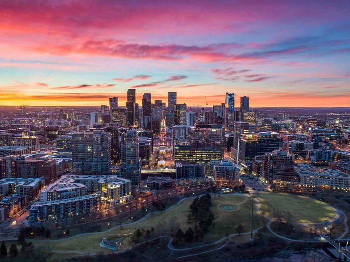 An aerial view of a city skyline at sunset.