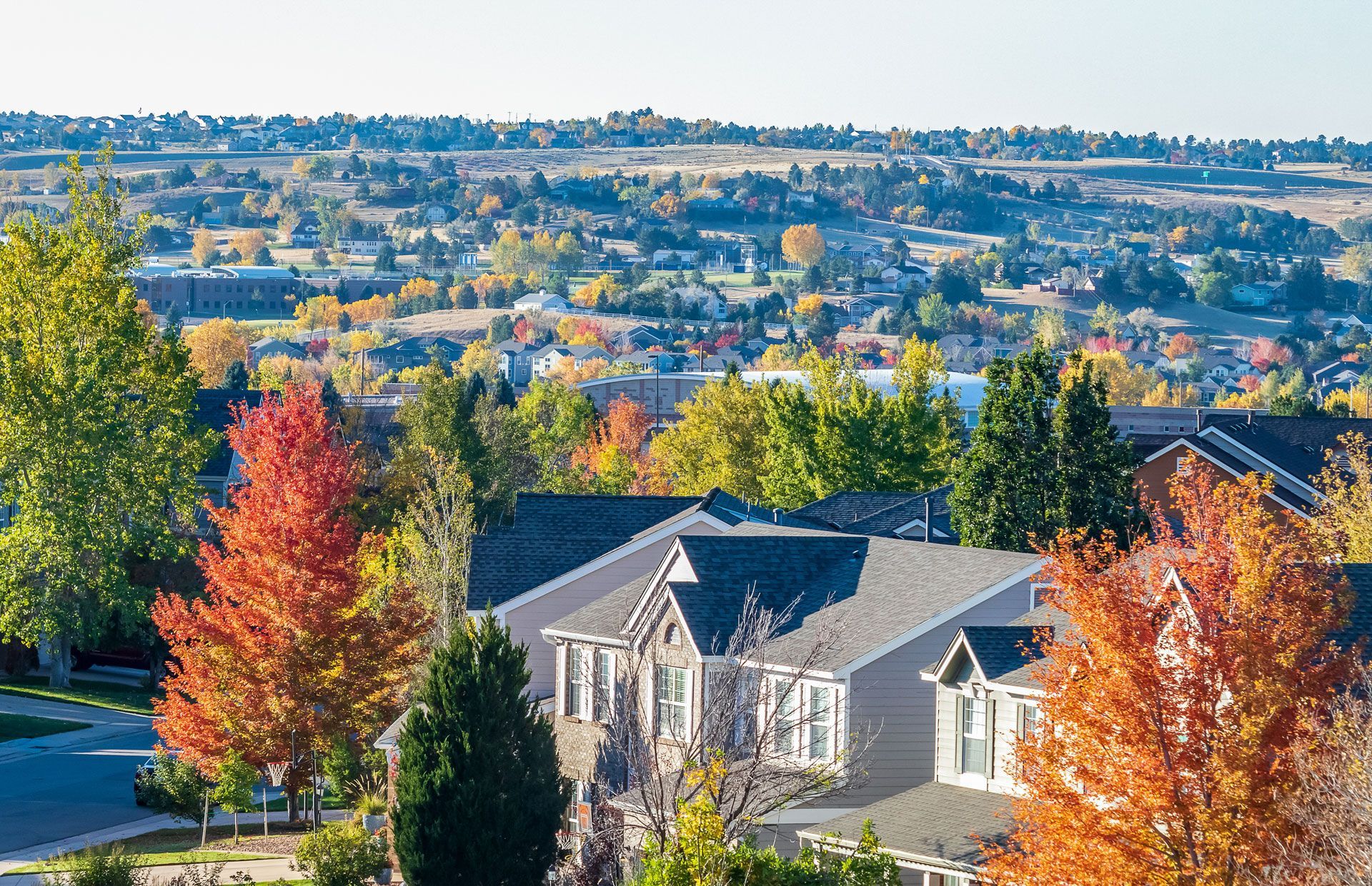 An aerial view of a residential neighborhood filled with lots of houses and trees.