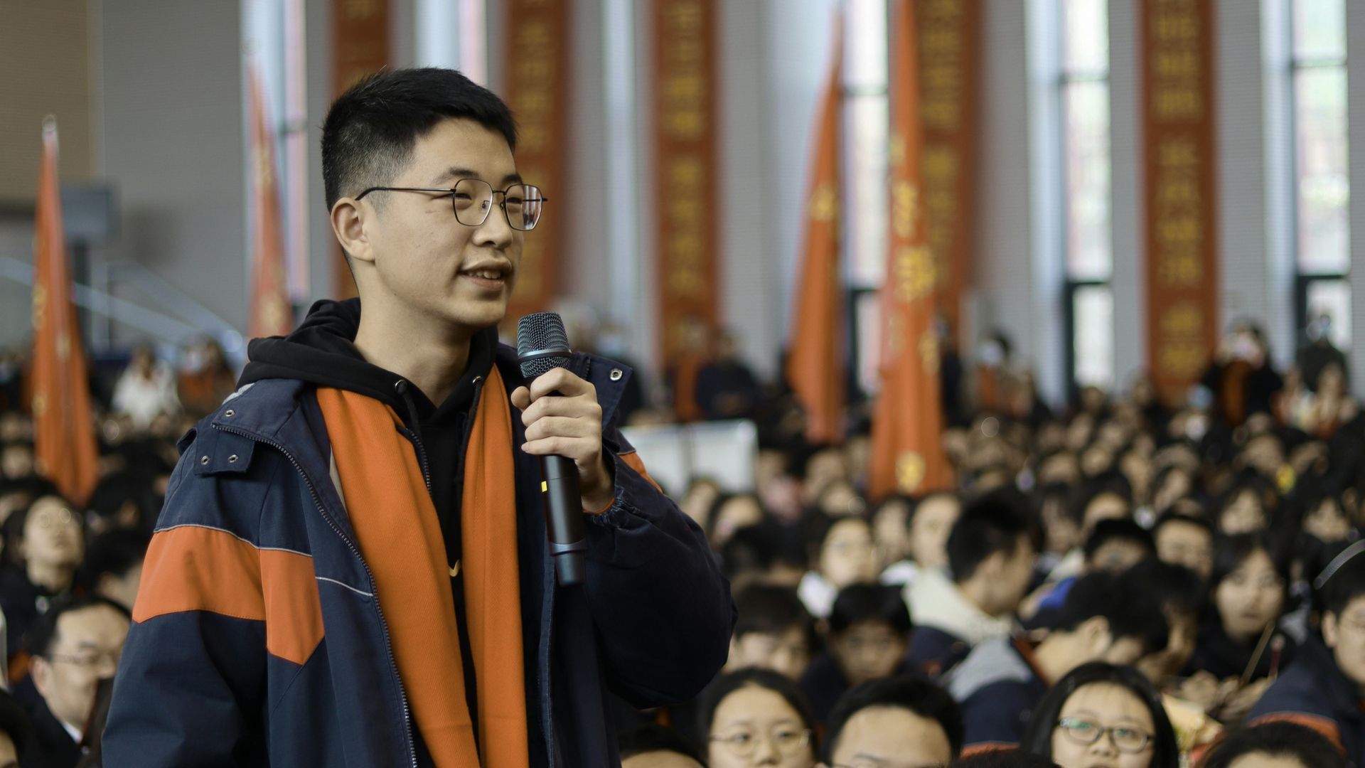 a woman with a scarf around her neck looks at herself in the mirror