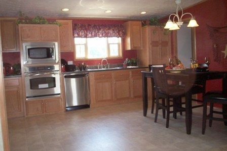 A kitchen with stainless steel appliances and wooden cabinets
