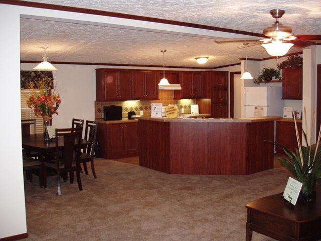 A kitchen and dining area with a ceiling fan