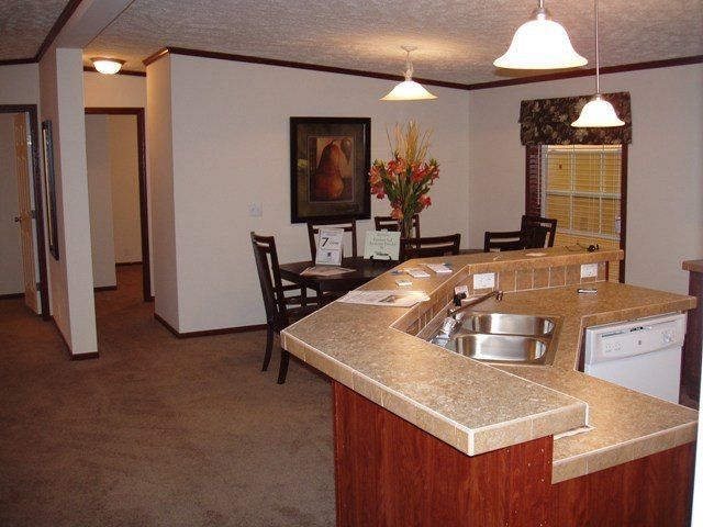 A kitchen with a sink and a table and chairs