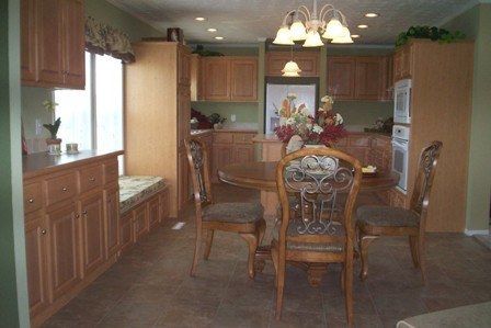 A kitchen with a table and chairs in it