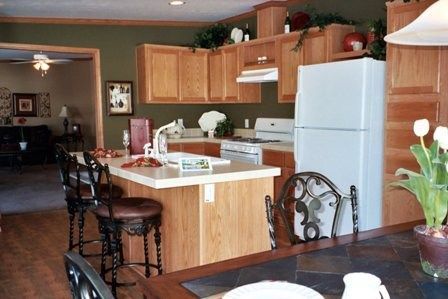 A kitchen with a table and chairs and a refrigerator