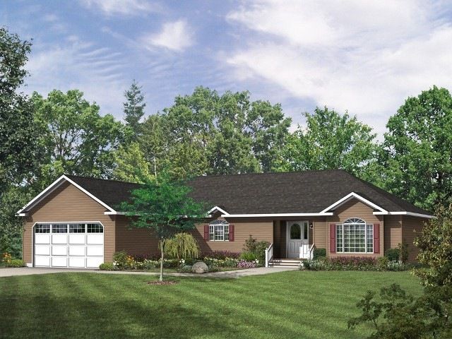 A brick house with a black roof and a white garage door