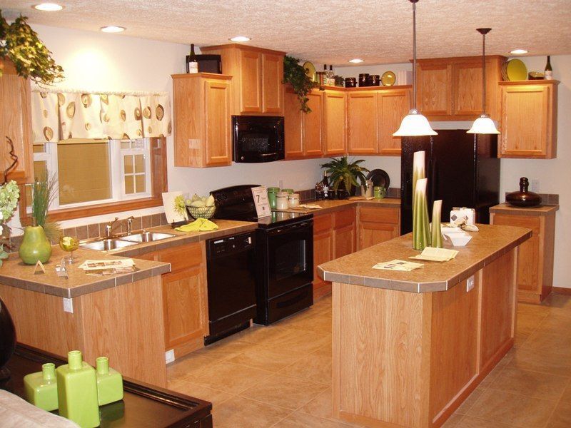 A kitchen with wooden cabinets and black appliances
