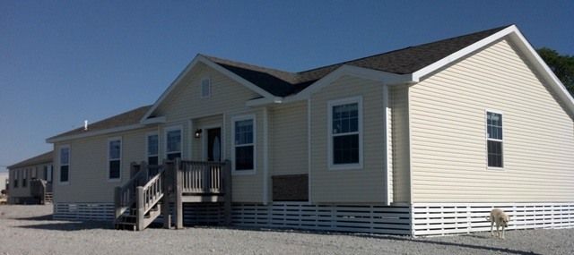 A large white house with a lot of windows and stairs