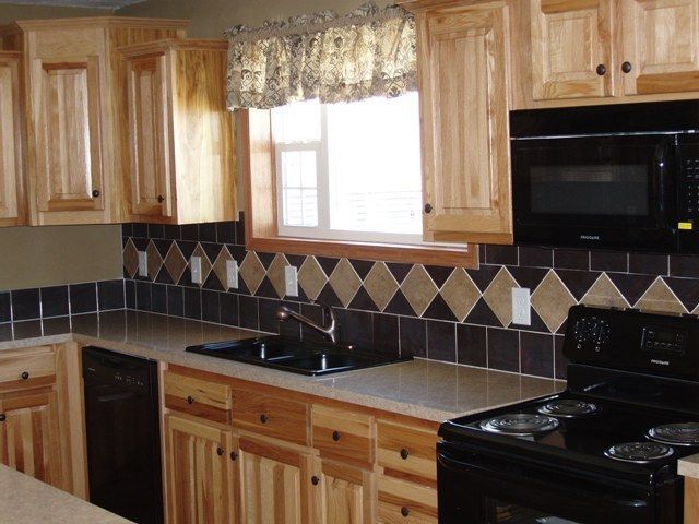 A kitchen with wooden cabinets and black appliances