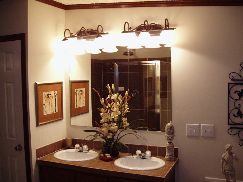 A bathroom with two sinks and a large mirror