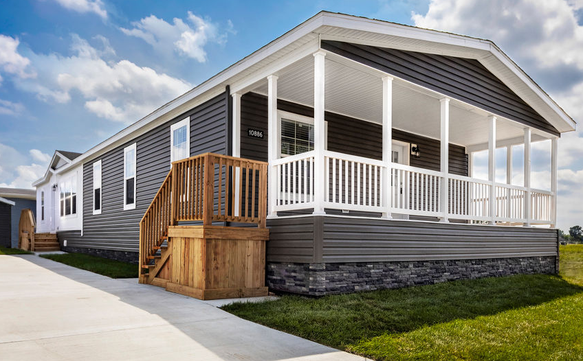 A white house with a gray roof and a white garage door