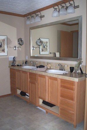A bathroom with two sinks and a large mirror
