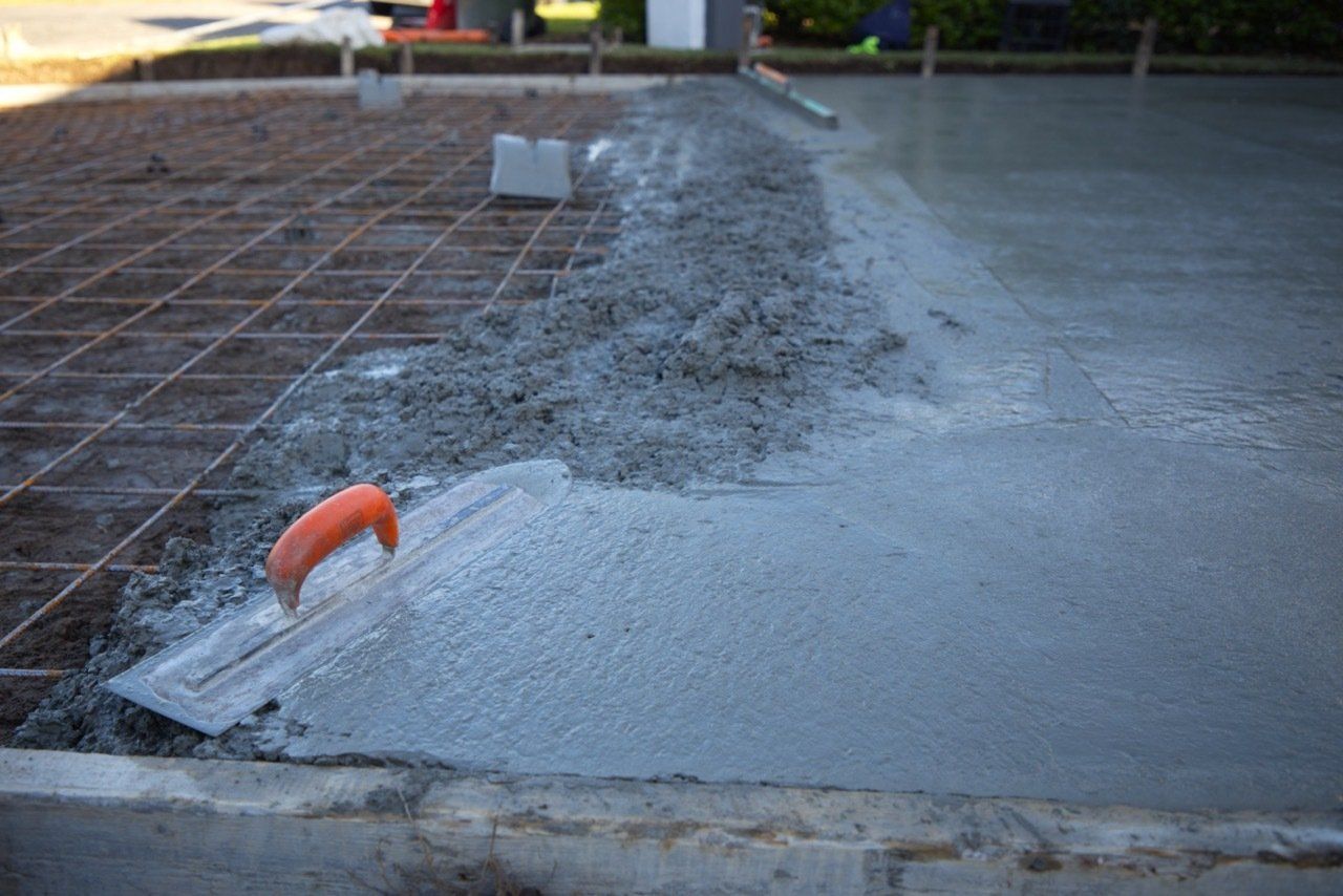 Concrete Being Spread With a Trowel — Easy Mix Concrete in Berkeley Vale, NSW