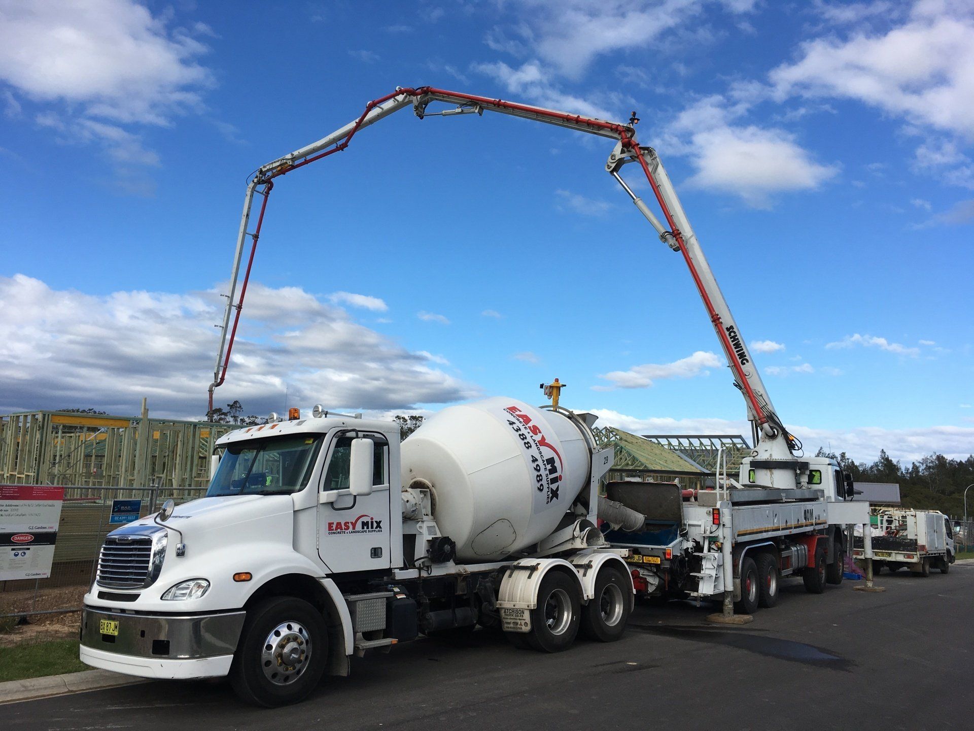 Cement Mixer Parked Outside Construction Site — Easy Mix Concrete in Berkeley Vale, NSW
