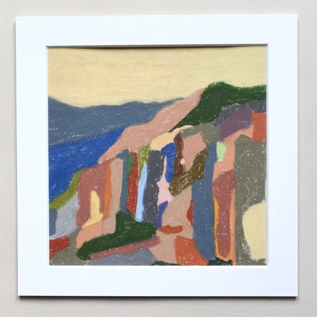 Colourful drawing of hillside with white border on grey background