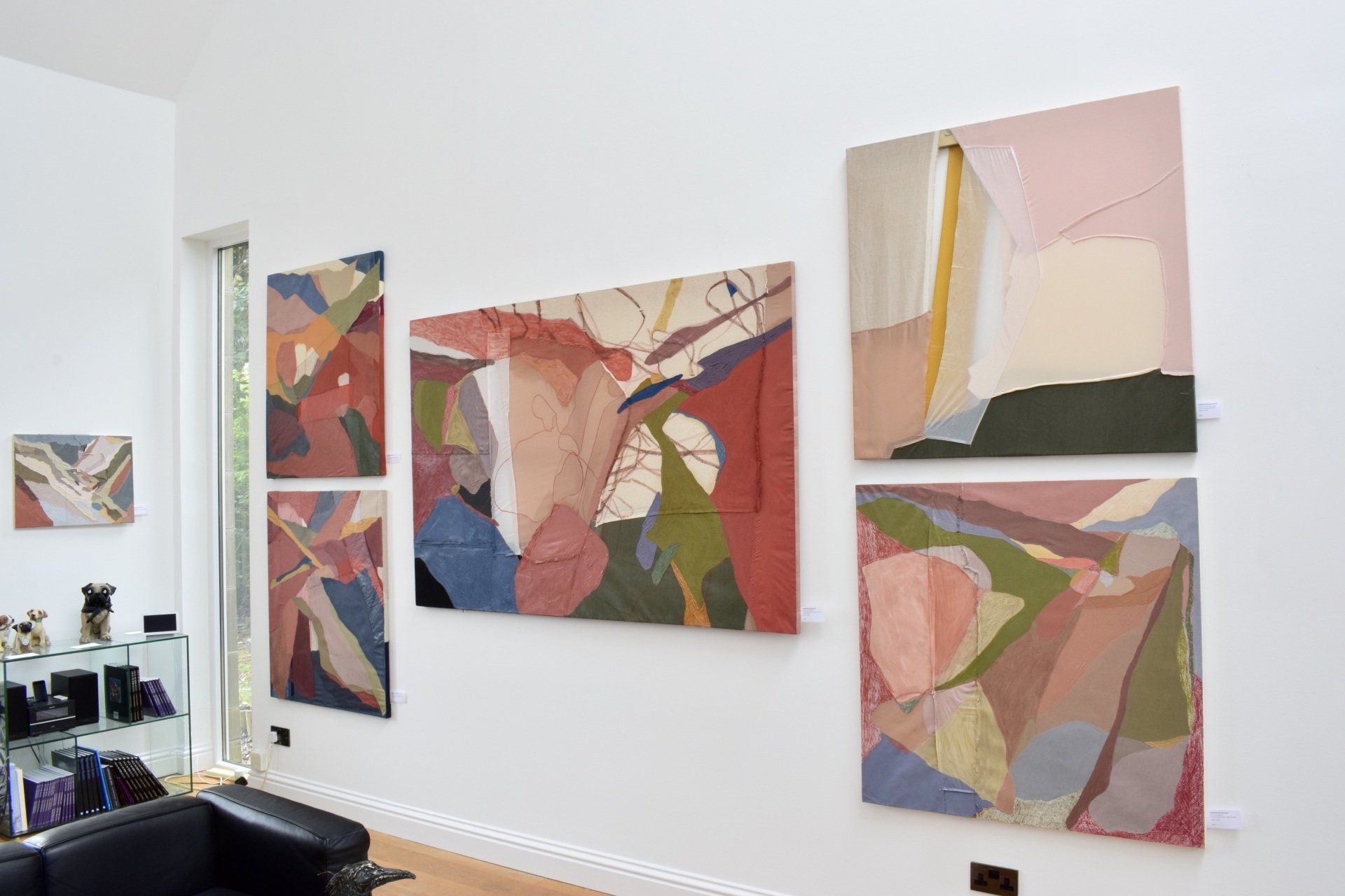 Photo of 6 colourful paintings on white wall