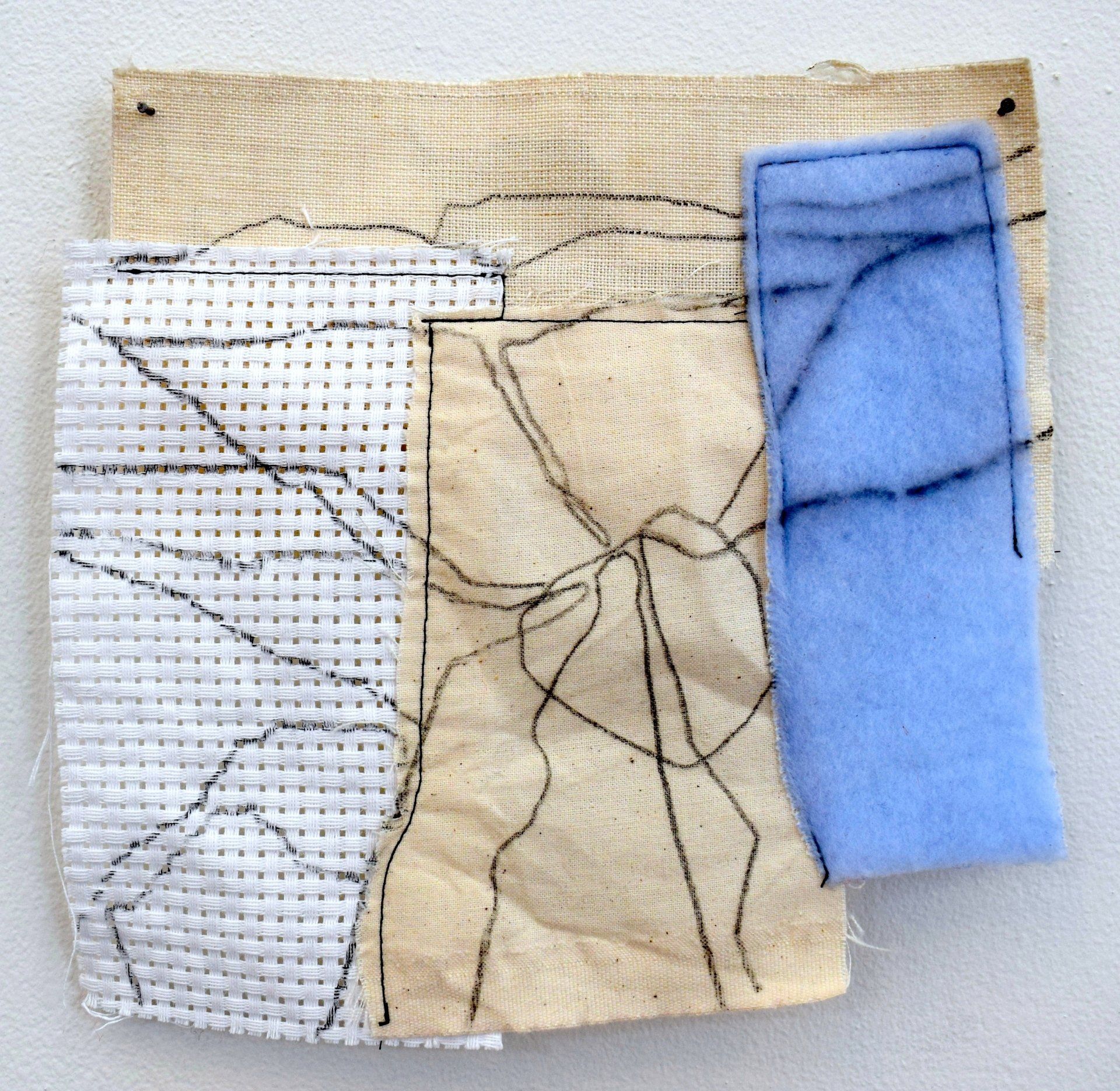 Small abstract line drawing on material. Blue, cream background