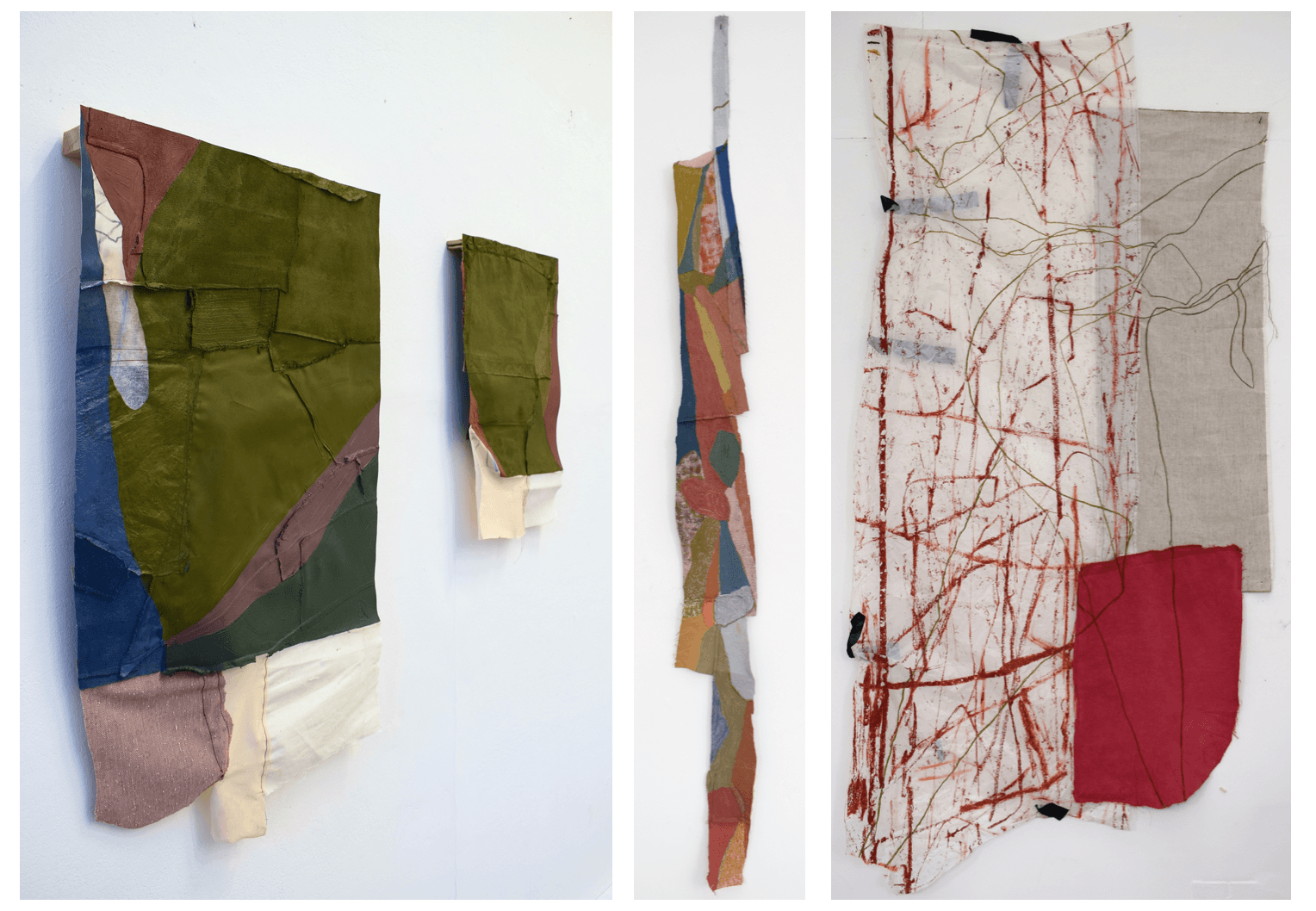 Four abstract paintings hanging from a white gallery wall