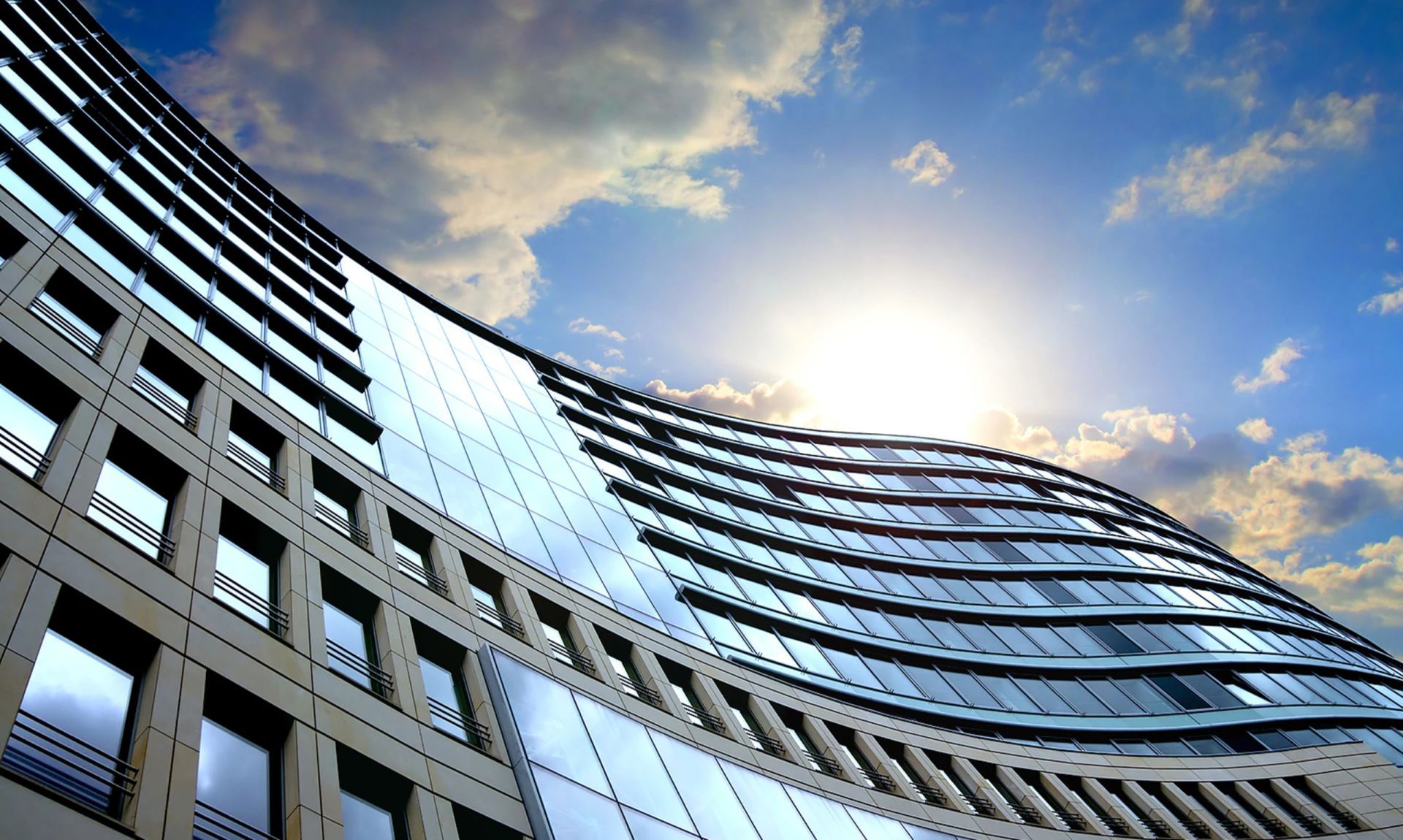 Looking up at a tall building with a blue sky in the background