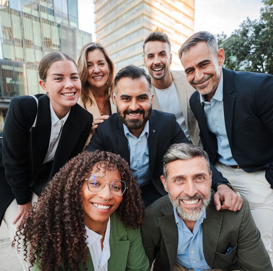 A group of people posing for a picture in front of a building