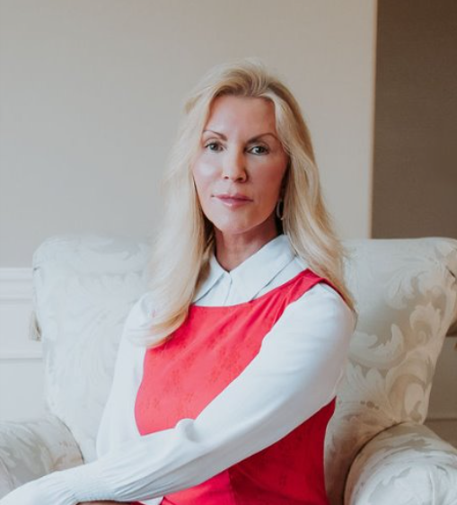 A woman in a red dress is sitting in a chair
