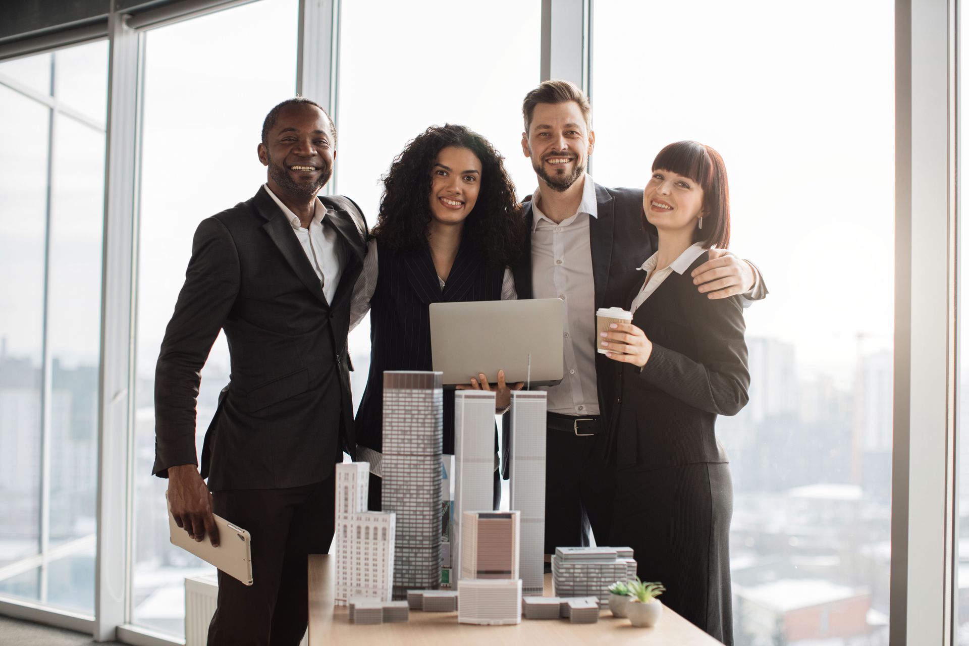 A group of business people are posing for a picture in an office.