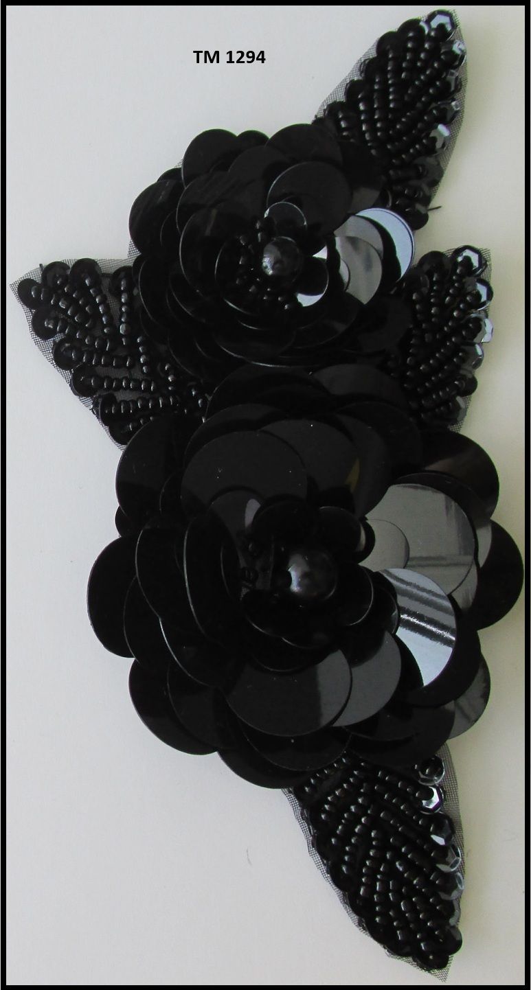 A close up of a black flower on a white background