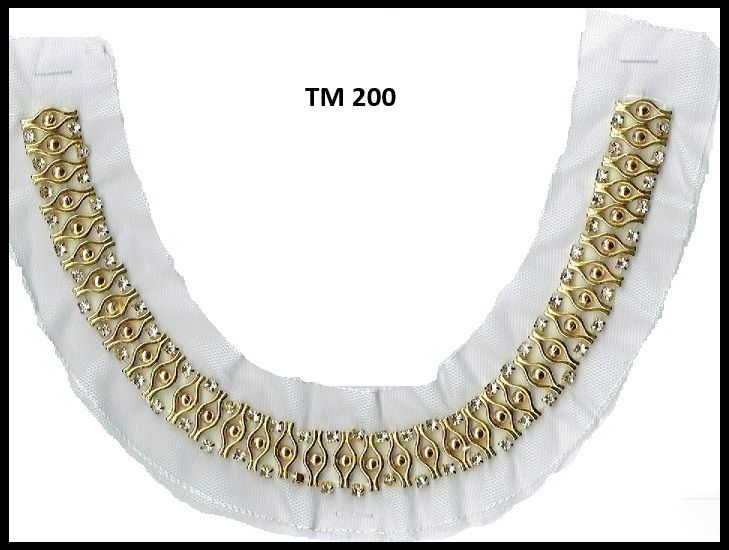 A white collar with gold beads and tm 200 on the bottom