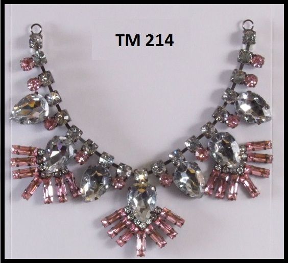 A necklace with pink and clear stones is labeled tm 214