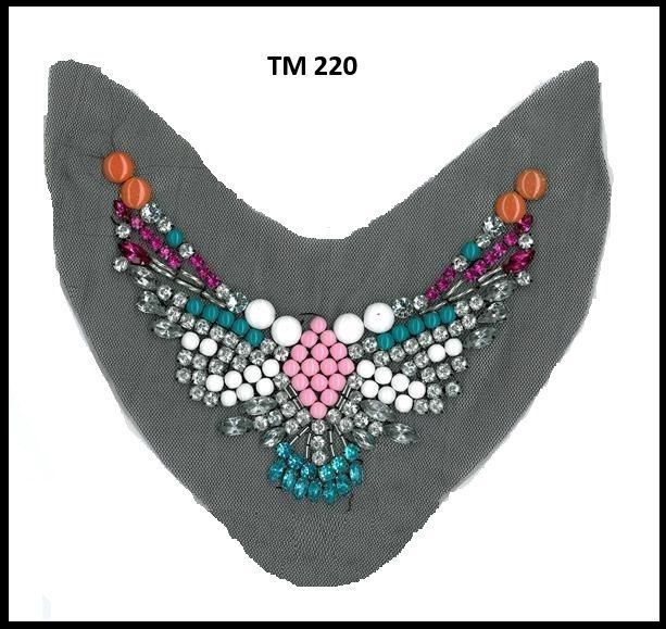 A gray piece of fabric with beads and rhinestones on it