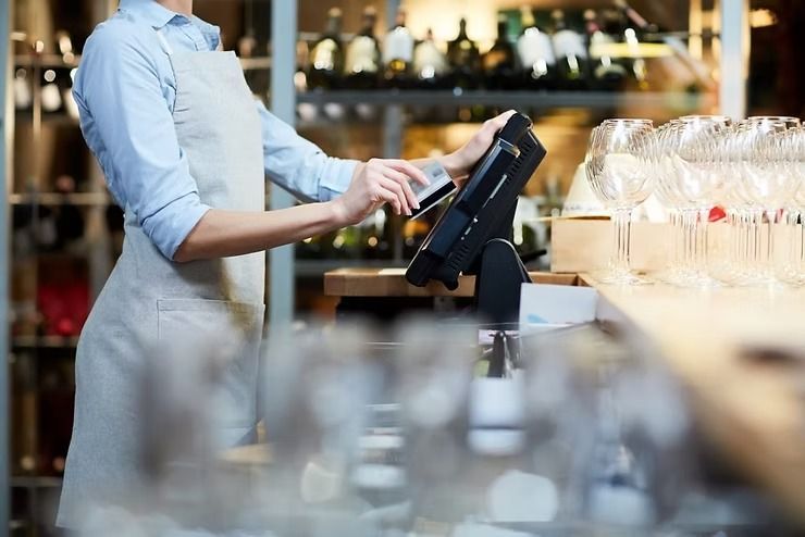A Woman Is Using a Computer at A Restaurant — Early Bird Accounts in Tamworth, NSW