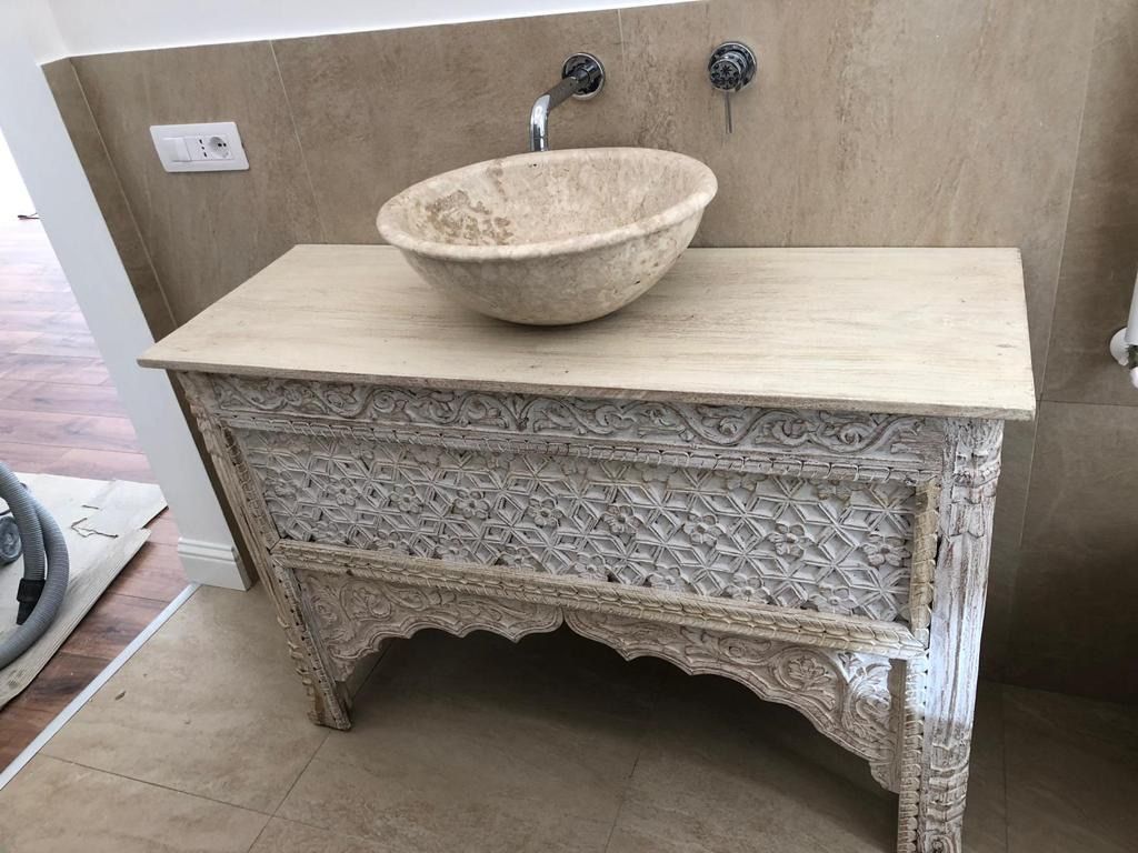 Un mobiletto del bagno con un lavandino sopra.