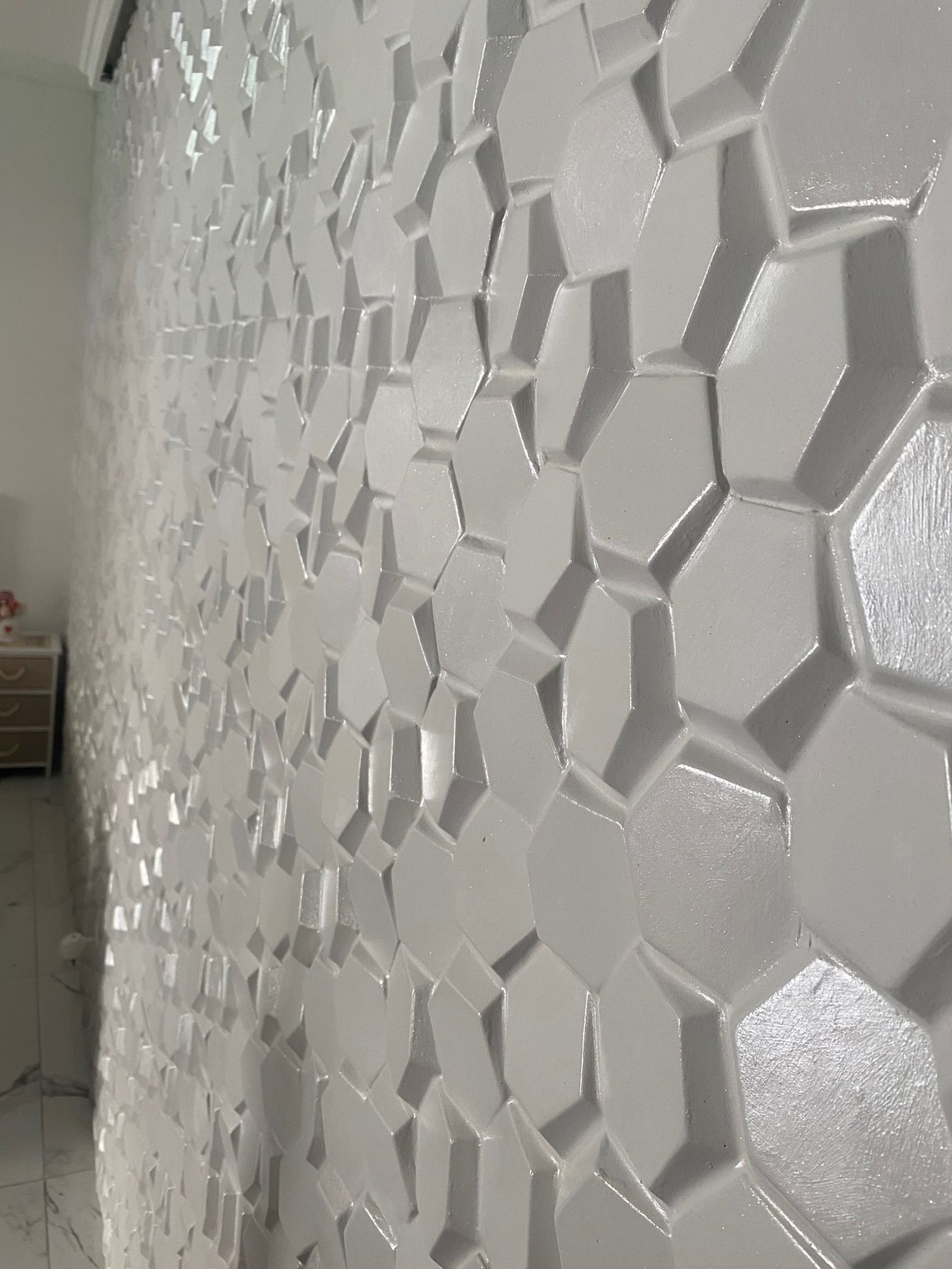 Un muro bianco con un motivo a nido d'ape.