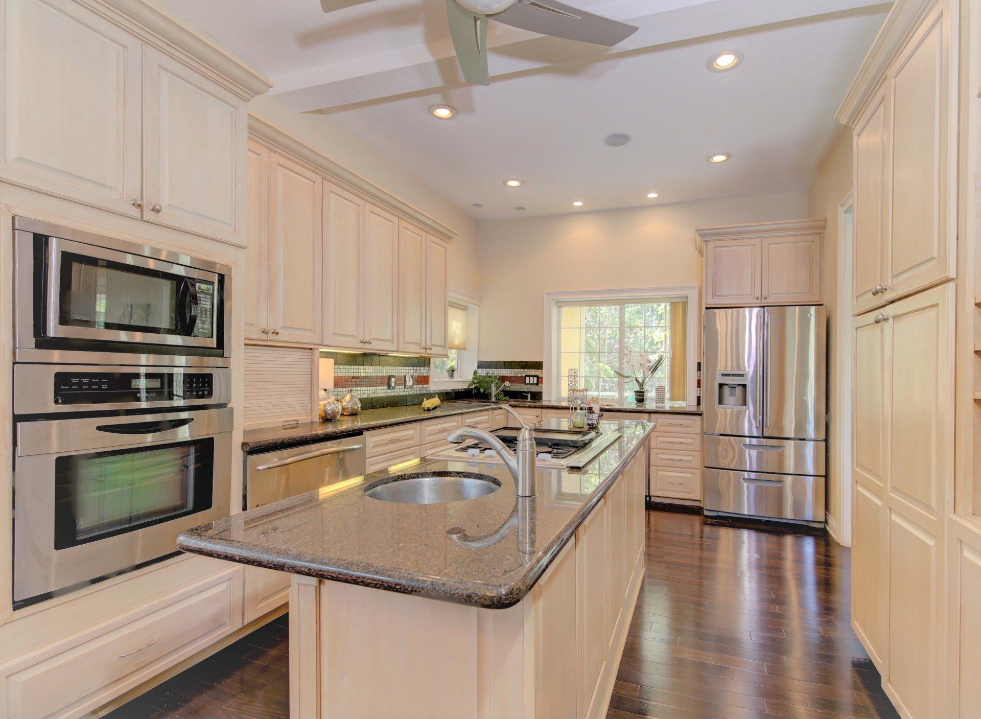 A kitchen with stainless steel appliances and granite counter tops.