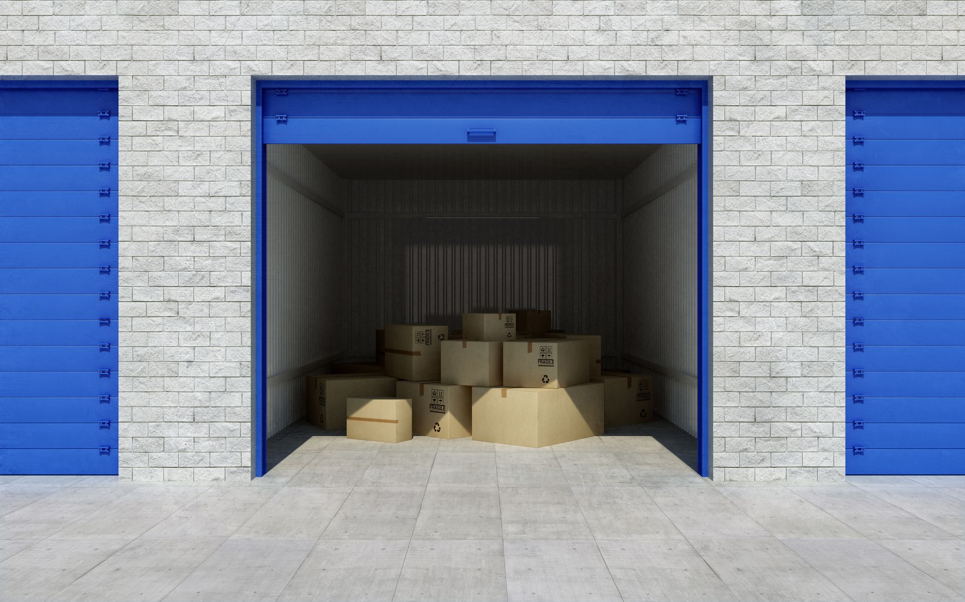 Open self-storage unit with stacked cardboard boxes inside.