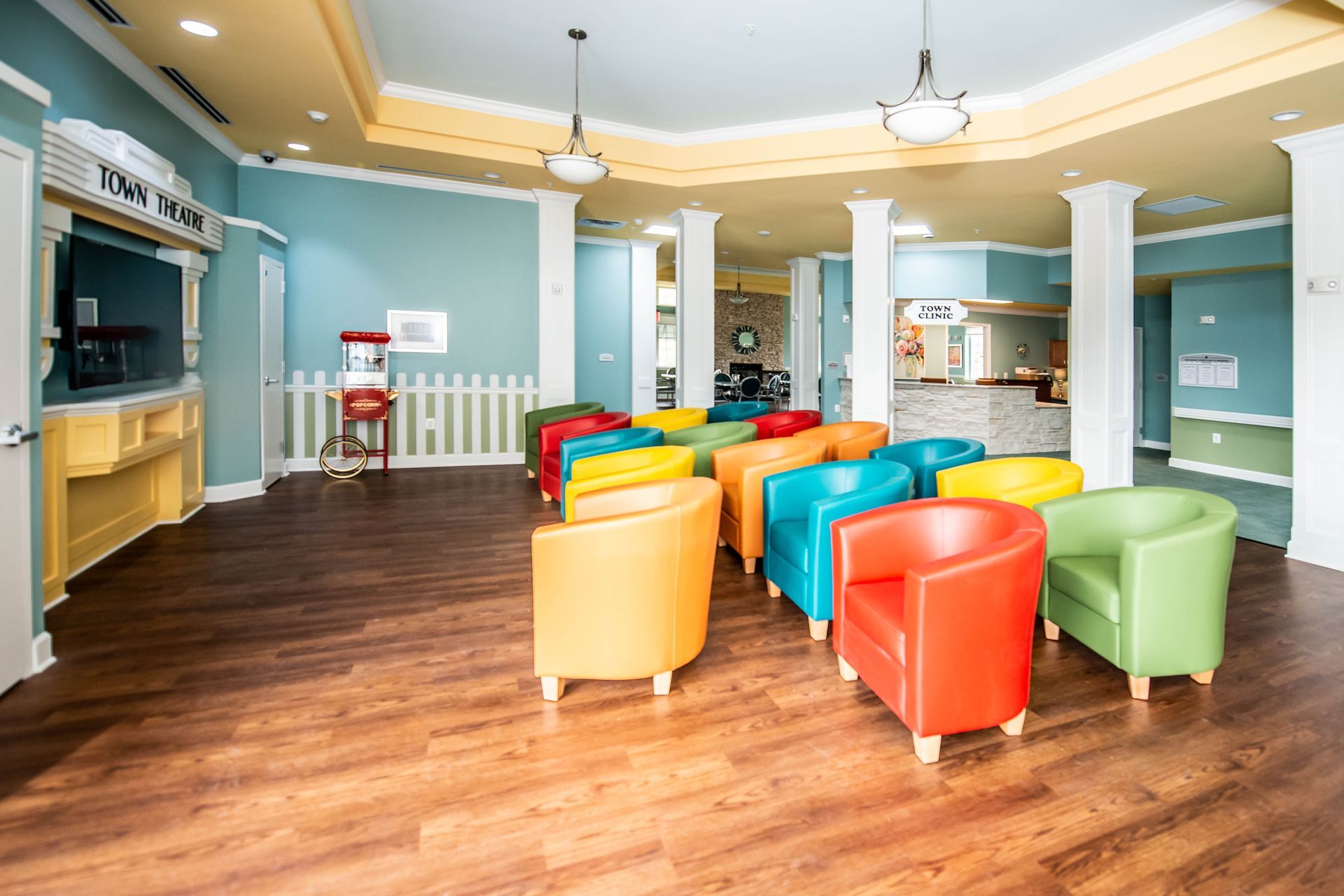 A large room filled with colorful chairs and a popcorn machine.
