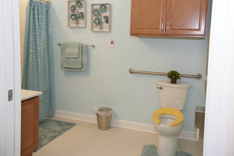 A bathroom with a toilet , sink , and shower.