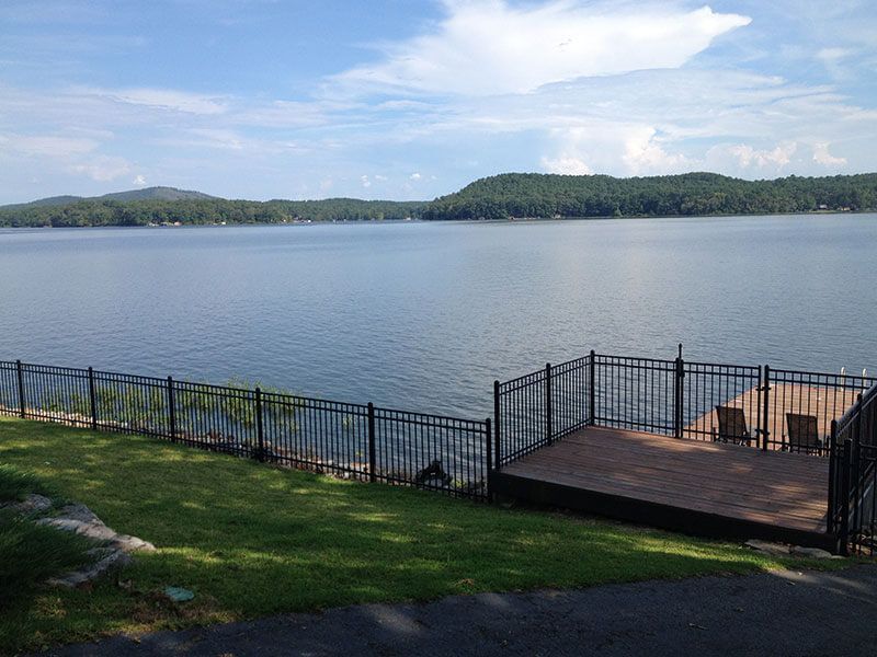 A large body of water surrounded by a fence and a dock.