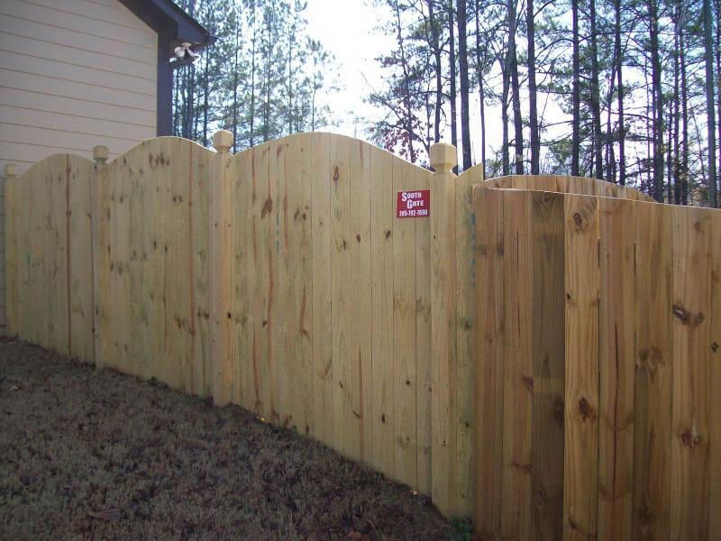 A wooden fence with a sign on it that says no dogs