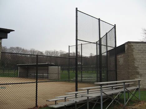 A baseball field with a chain link fence and bleachers