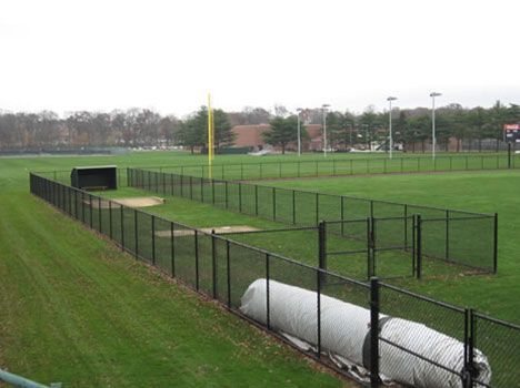 A baseball field with a fence surrounding it