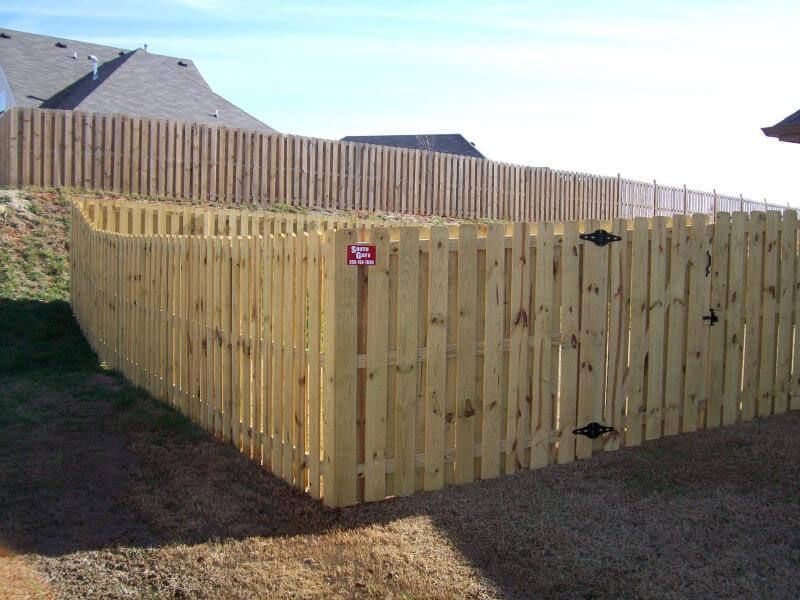 A wooden fence with a sign that says no dogs