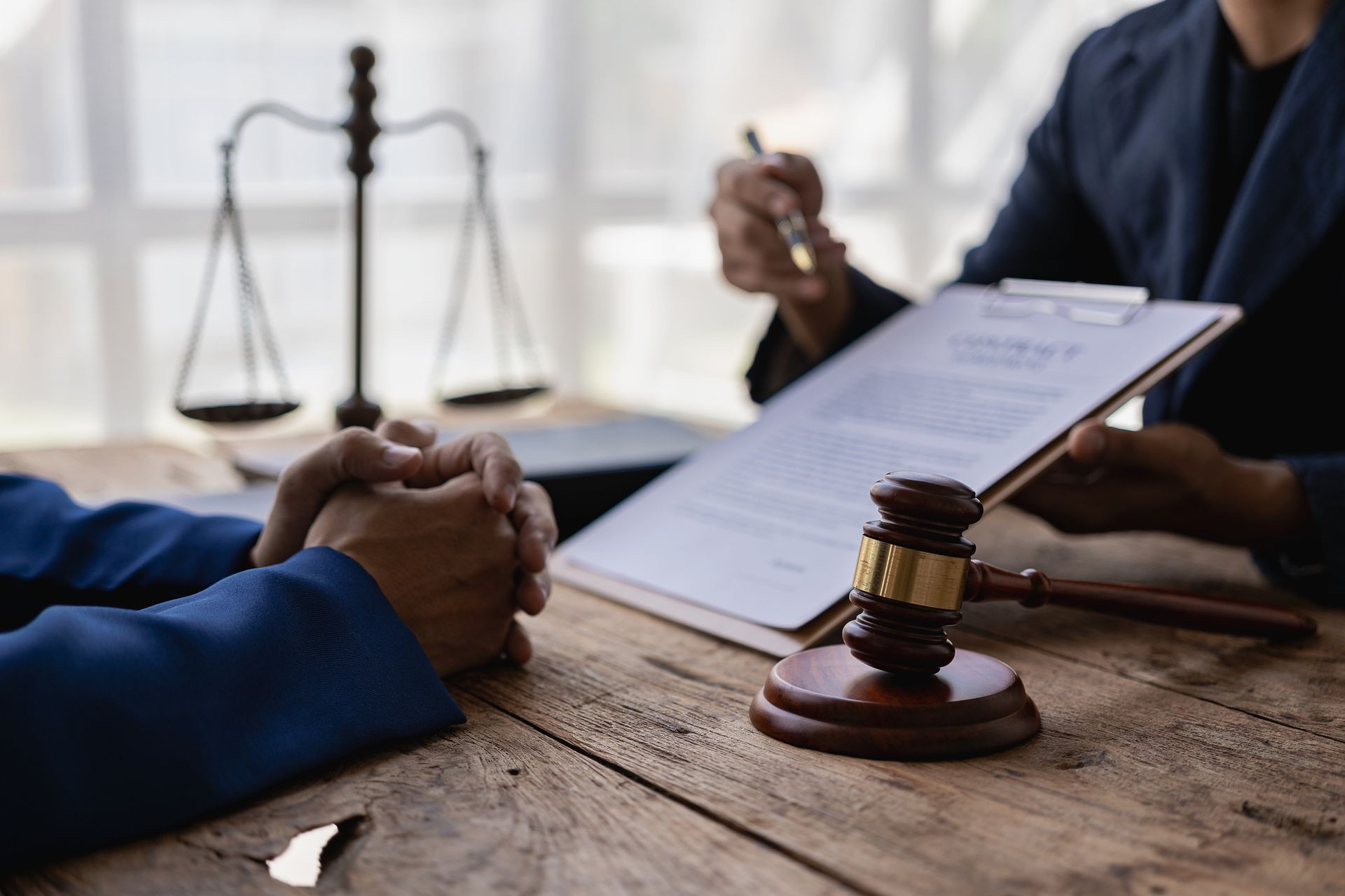 A lawyer is explaining a document to a person.