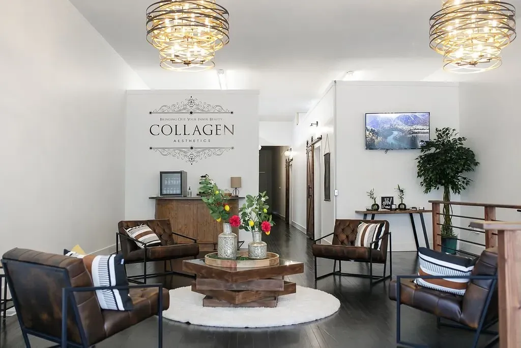 Lounge area of a spa with leather chairs, wood accents, and decorative light fixtures.