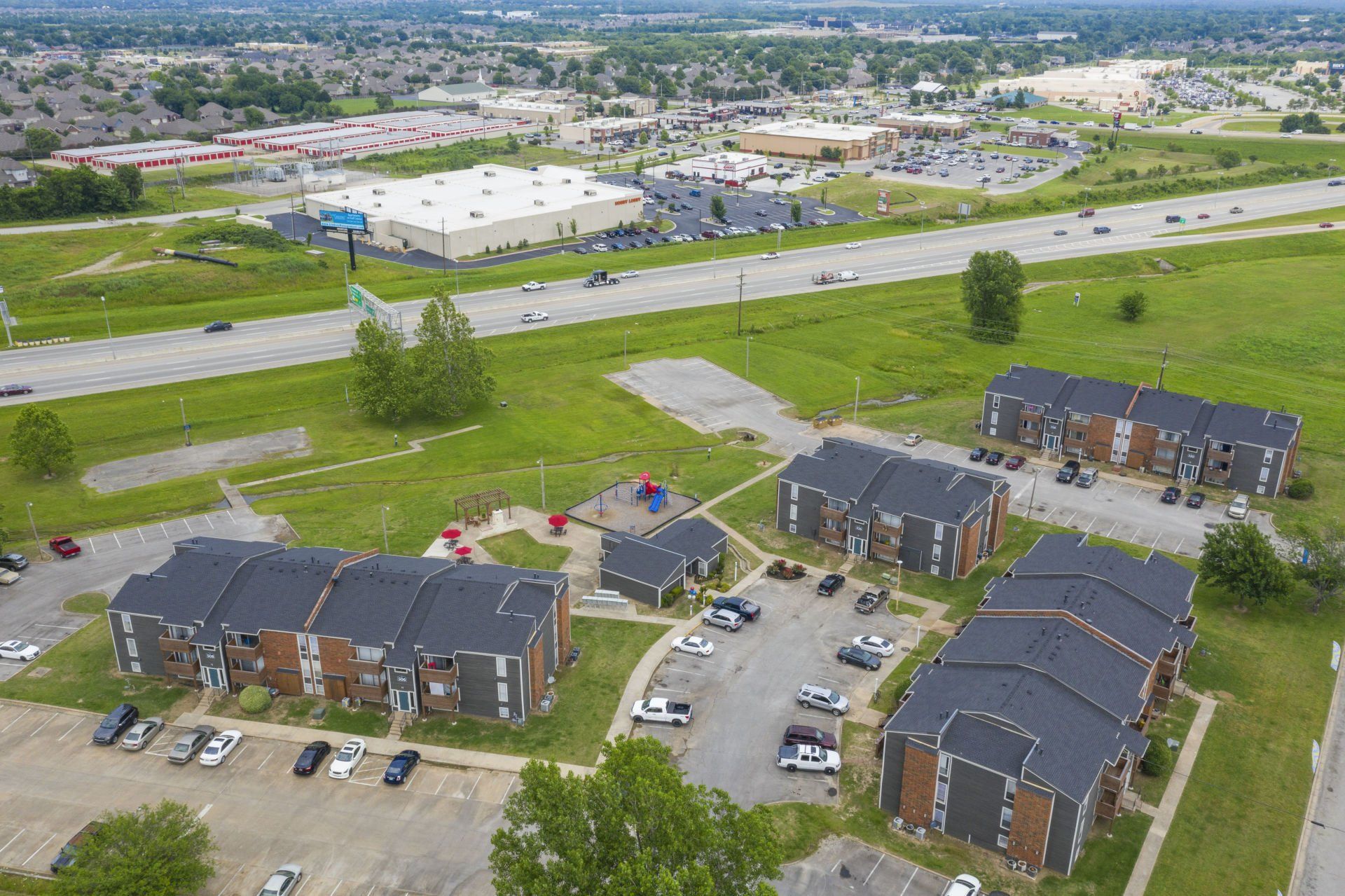 An aerial view of a residential area with buildings and a parking lot.