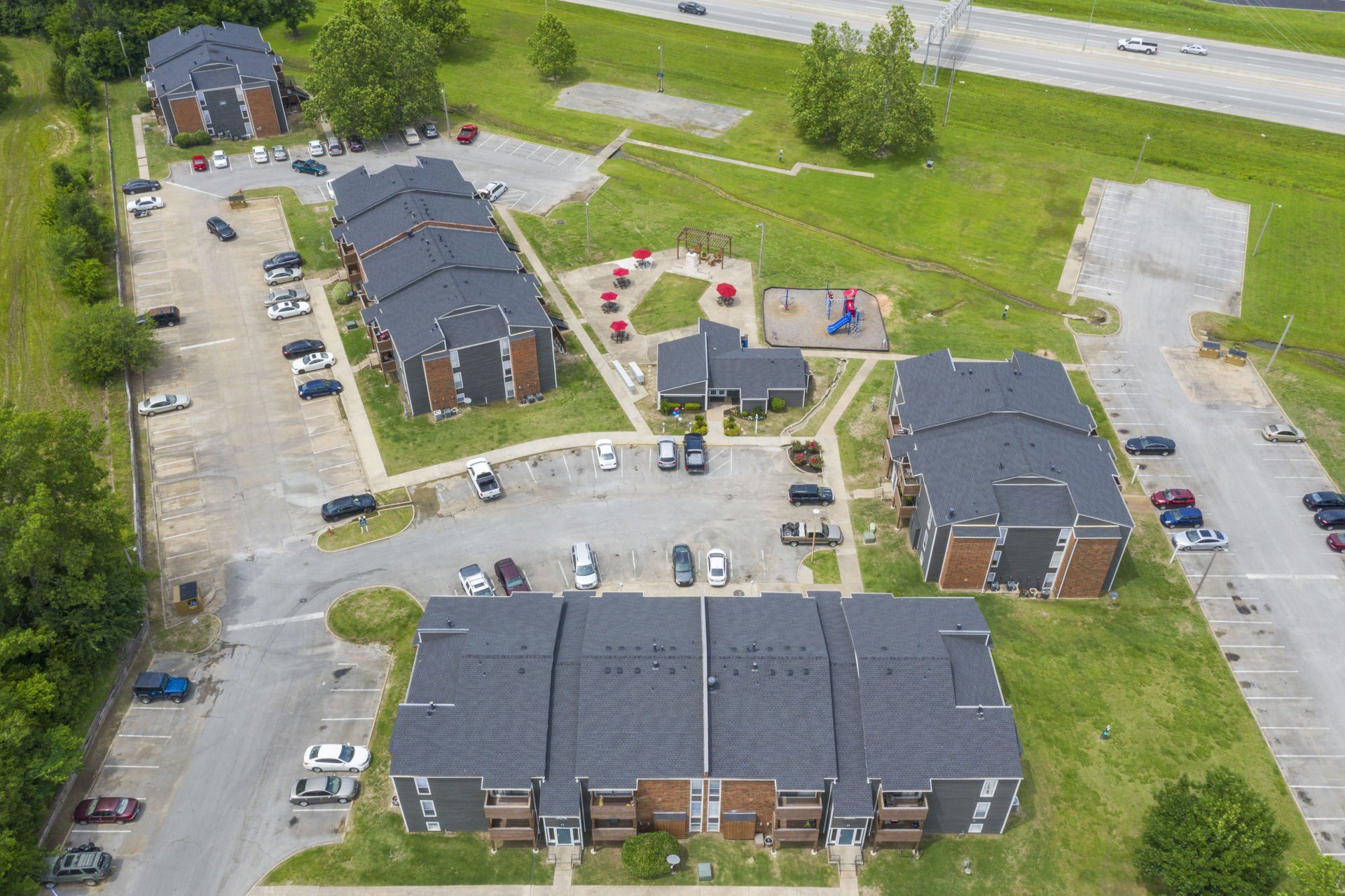 An aerial view of a residential area with buildings and parking lots