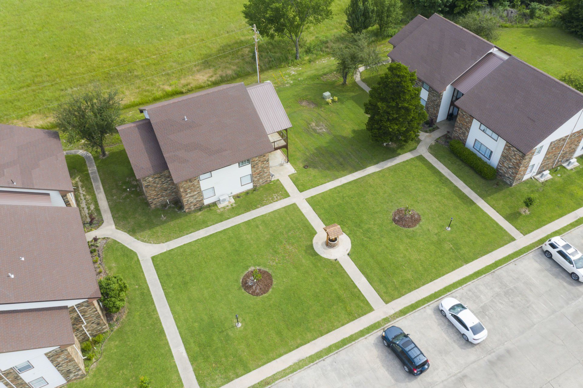 An aerial view of a residential area with houses and a parking lot.
