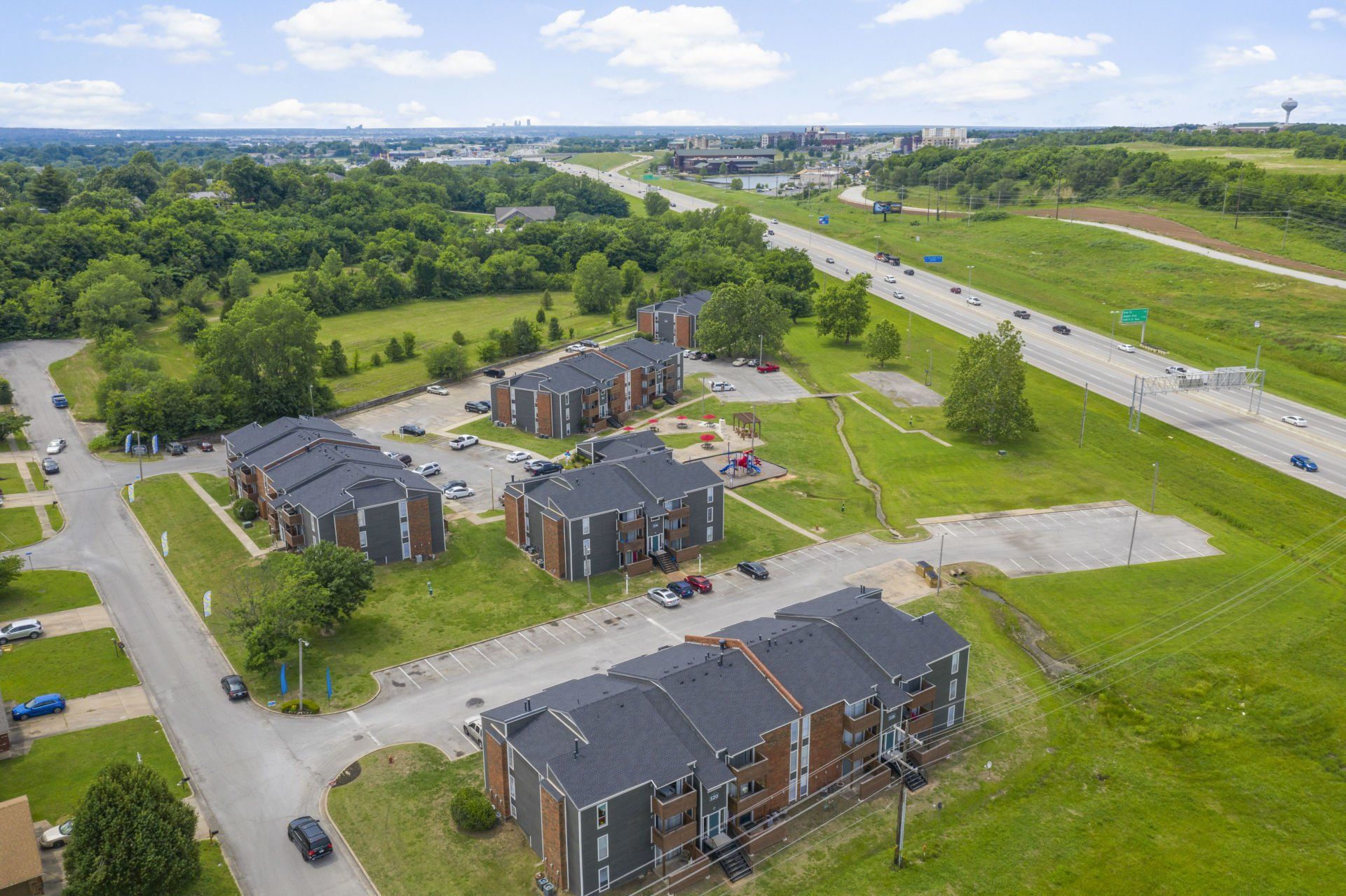 An aerial view of a residential area with a highway in the background.