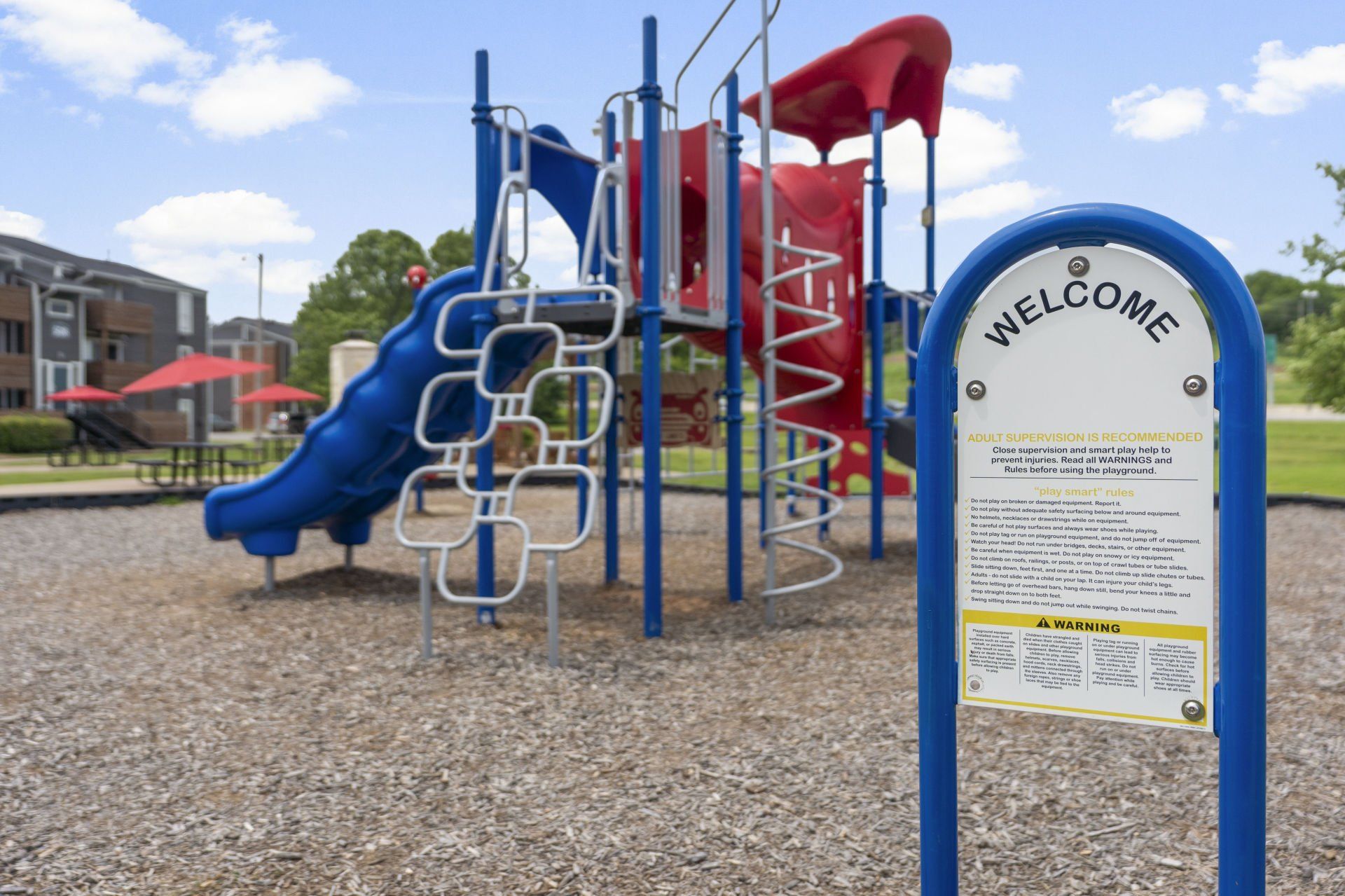 A playground with a welcome sign in front of it.